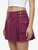 Purple skirt with buckles and pockets worn by a person on a white background