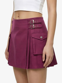 Purple skirt with buckles and pockets worn by a person on a white background
