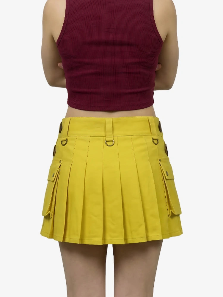 Person wearing a maroon crop top and yellow pleated skirt on a white background