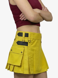 Yellow skirt with black accents worn by a person on a white background
