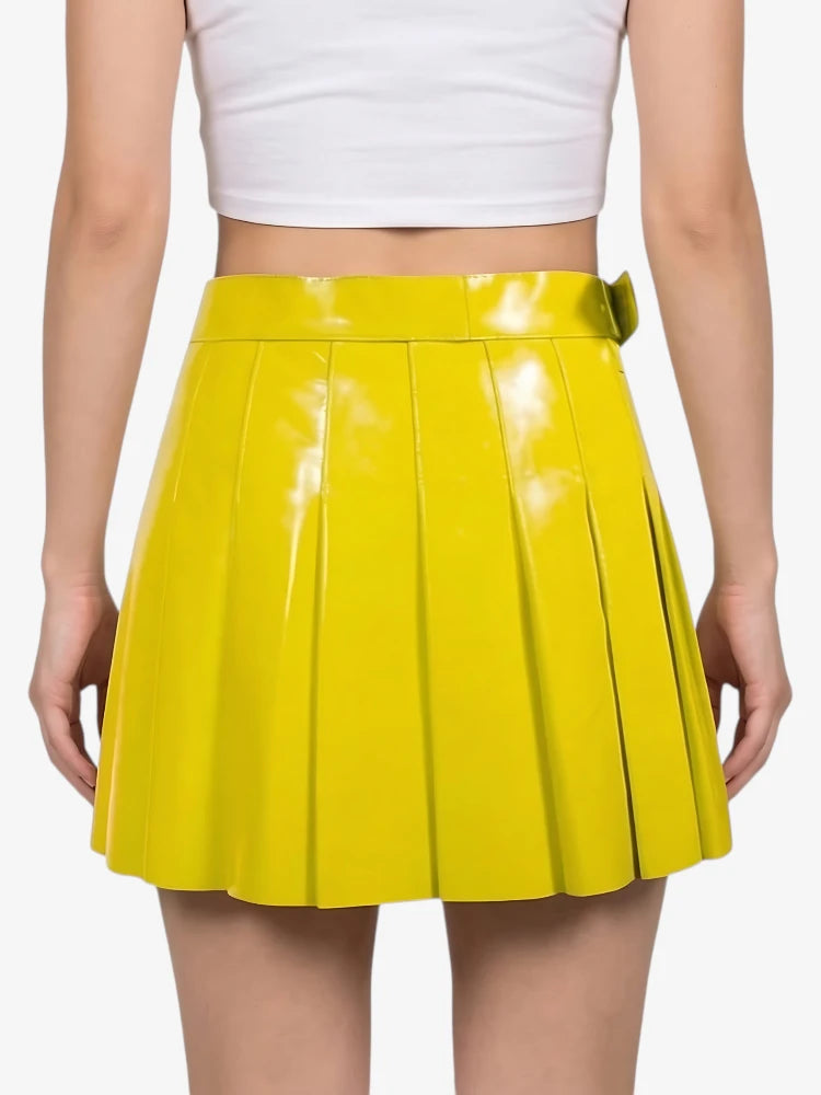 Yellow pleated skirt worn by a person on a white background