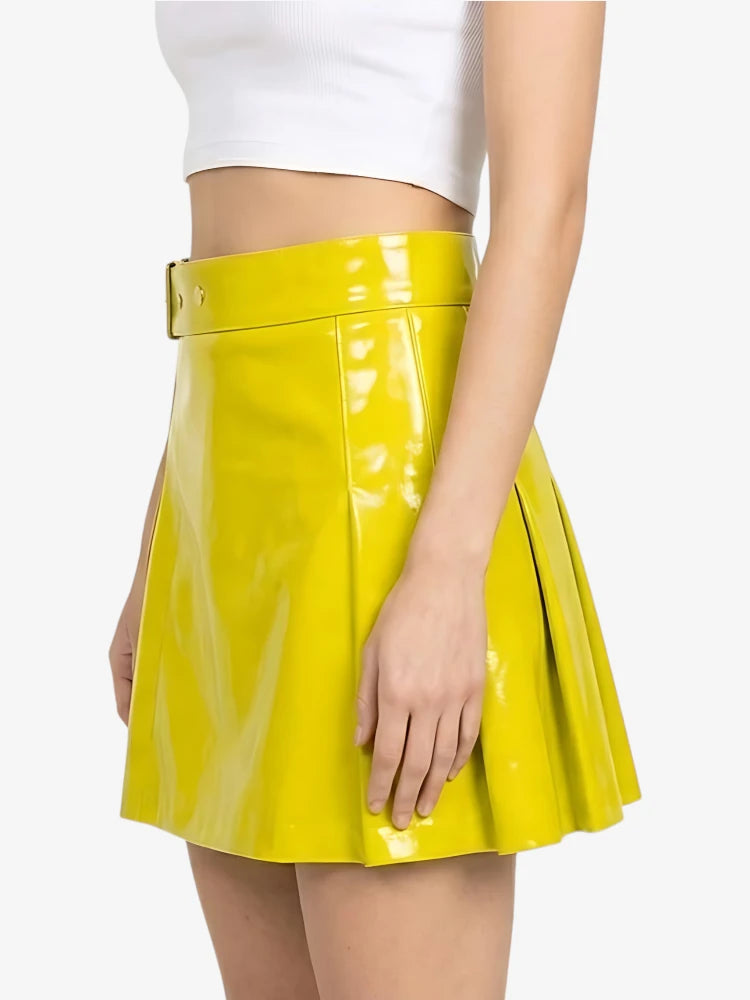 Yellow skater skirt worn with a white top on a plain background