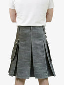 Person wearing a gray denim kilt on a white background