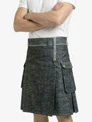 Person wearing a gray denim kilt on a white background