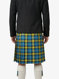 Person wearing a black coat over a blue and yellow plaid kilt on a white background