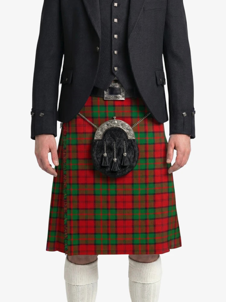 Person wearing a red tartan kilt with a black jacket on a white background