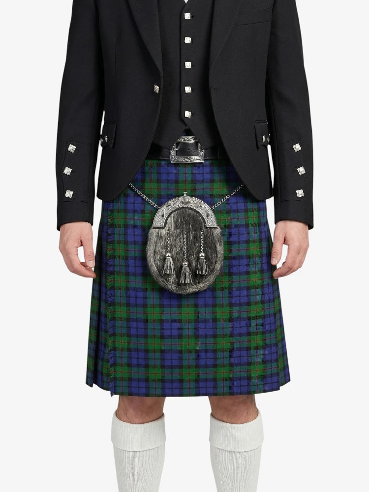 Person wearing a Scottish kilt with a tartan pattern on a white background