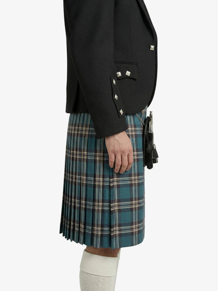 Person wearing a black jacket and blue plaid kilt on a white background