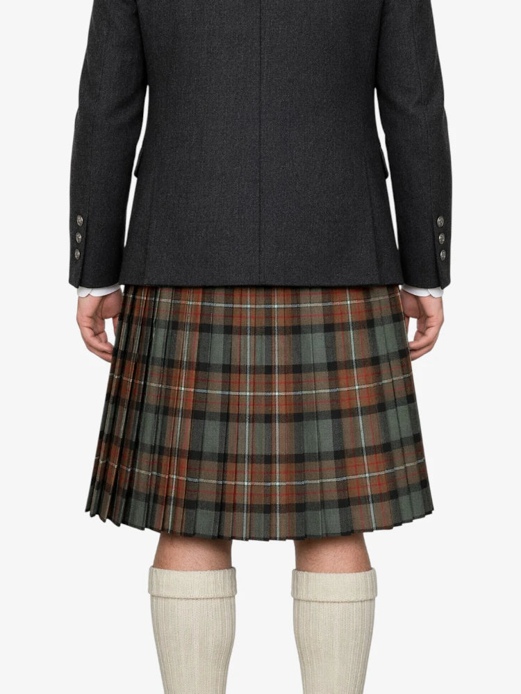 Person wearing a dark jacket and plaid kilt on a white background