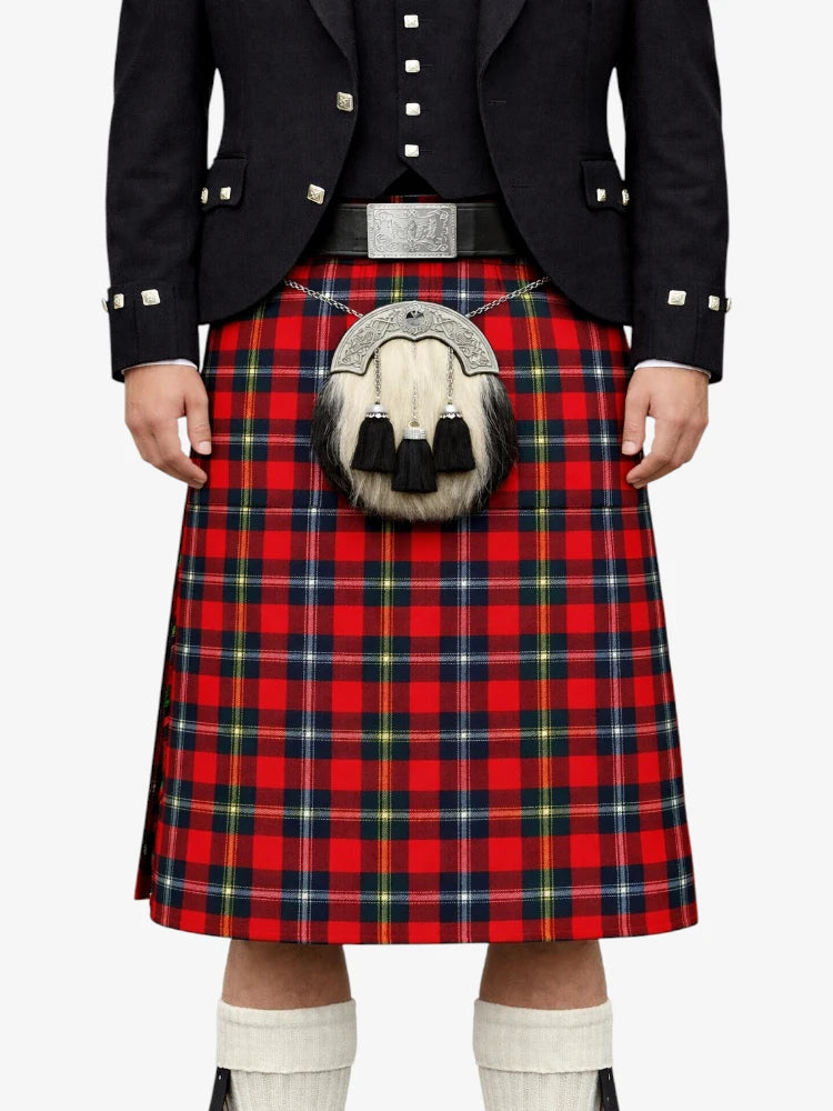 Person wearing a red tartan kilt with a black jacket on a white background