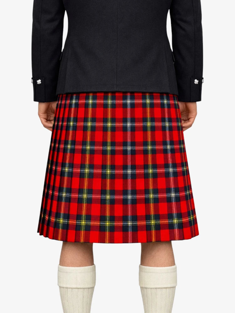 Person wearing a red plaid kilt with a black jacket on a white background