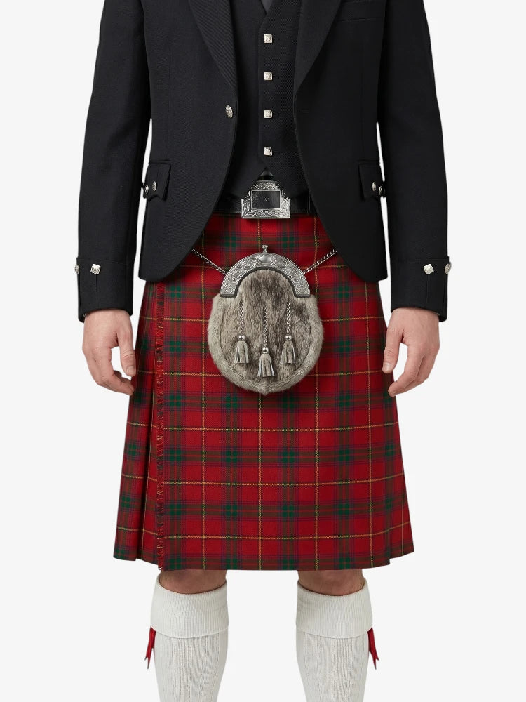 Person wearing a red tartan kilt with a black jacket and white socks on a white background