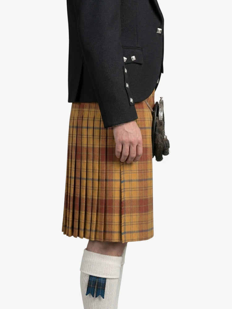 Person wearing a black jacket and yellow plaid kilt on a white background