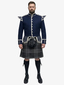 Man wearing a traditional Scottish grey watch tartan kilt with a navy doublet jacket on a white background