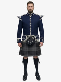 Man wearing a traditional Scottish grey watch tartan kilt with a navy doublet jacket on a white background