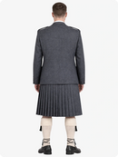 Person wearing a gray military-style jacket and pleated skirt on a white background