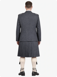 Person wearing a gray military-style jacket and pleated skirt on a white background