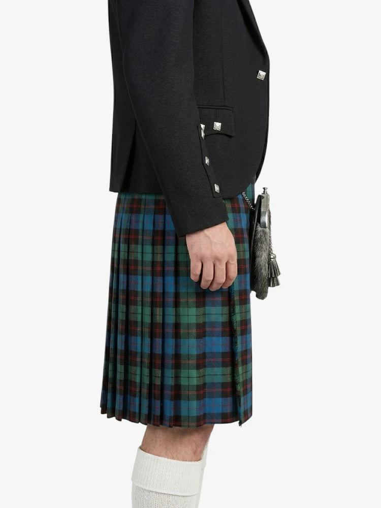 Person wearing a black jacket and plaid kilt on a white background