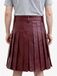 Person wearing a Burgundy pleated skirt and gray t-shirt on a white background