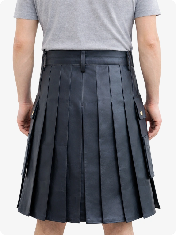 Person wearing a black pleated kilt on a white background