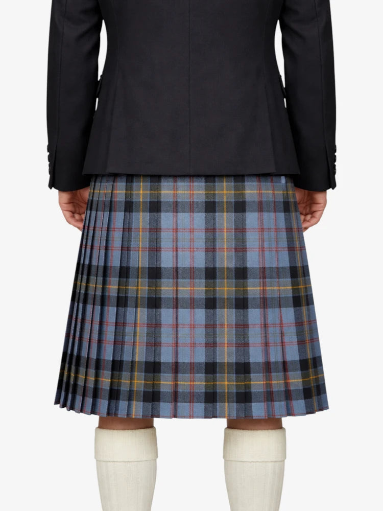 Person wearing a black jacket and plaid kilt on a white background