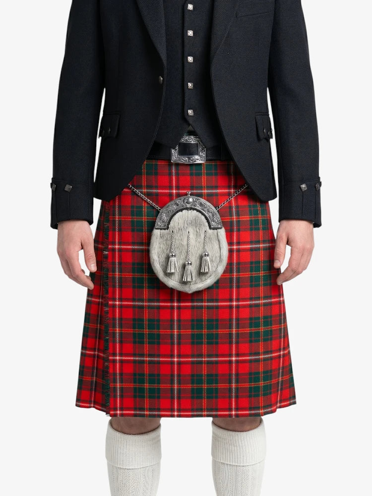 Person wearing a red tartan kilt with a black jacket on a white background