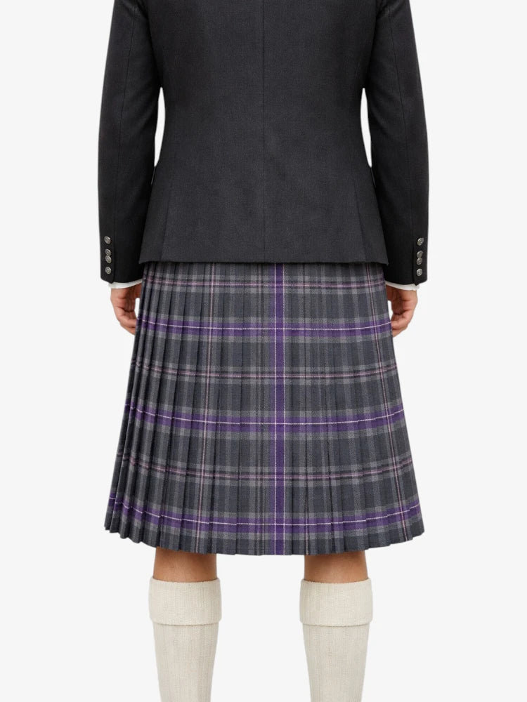 Person wearing a dark gray jacket and plaid kilt  on a white background