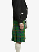Green plaid kilt worn with a black jacket on a white background