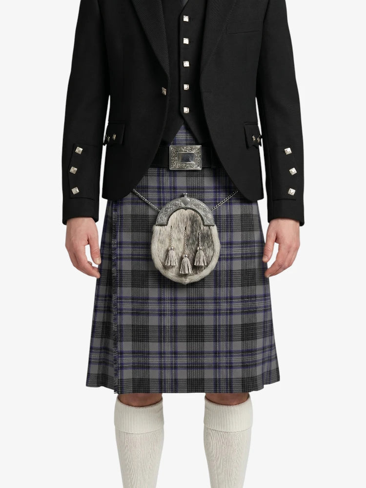 Person wearing a traditional Scottish kilt with a jacket on a white background