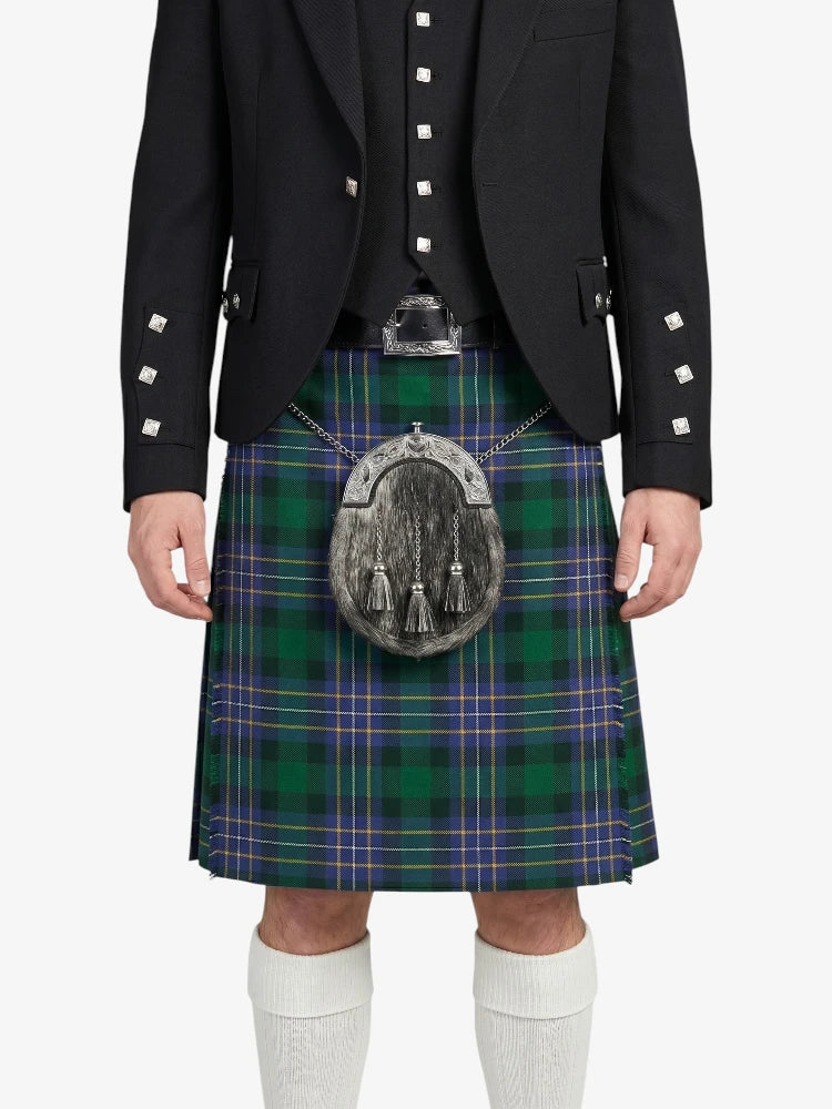 Person wearing a black jacket and green plaid kilt on a white background