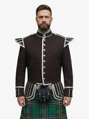 Man wearing a traditional Scottish irish national tartan kilt with a dark brown jacket on a white background