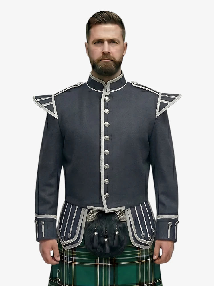 Man wearing a dark grey jacket with silver buttons and a irish national tartan plaid kilt on a white background