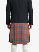 Person wearing a black coat and red plaid kilt on a white background