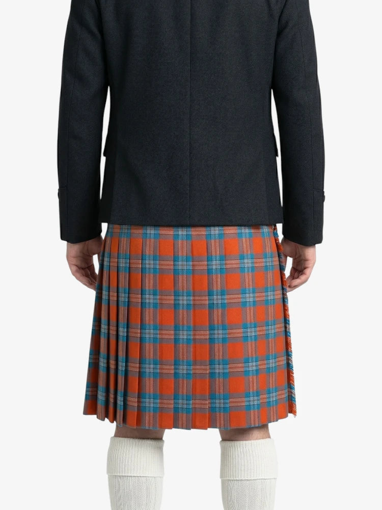 Person wearing a black coat and red plaid kilt on a white background