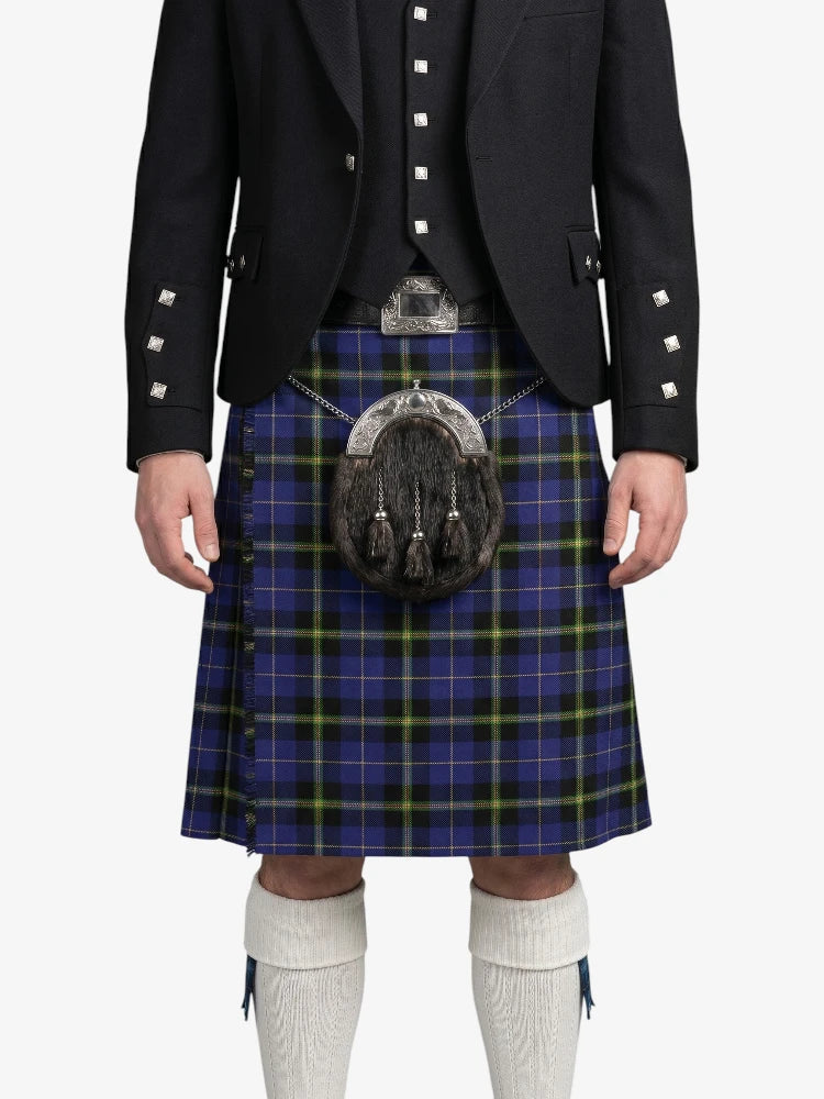Person wearing a traditional Scottish kilt with a jacket on a white background