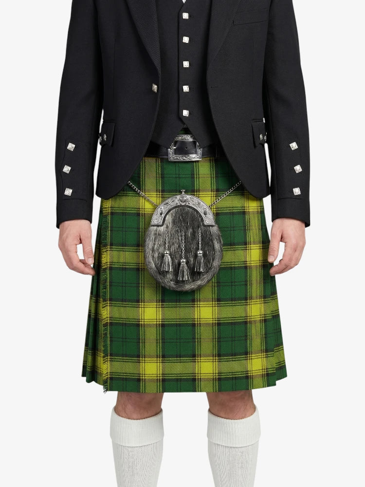 Person wearing a green and yellow plaid kilt with a black jacket on a white background