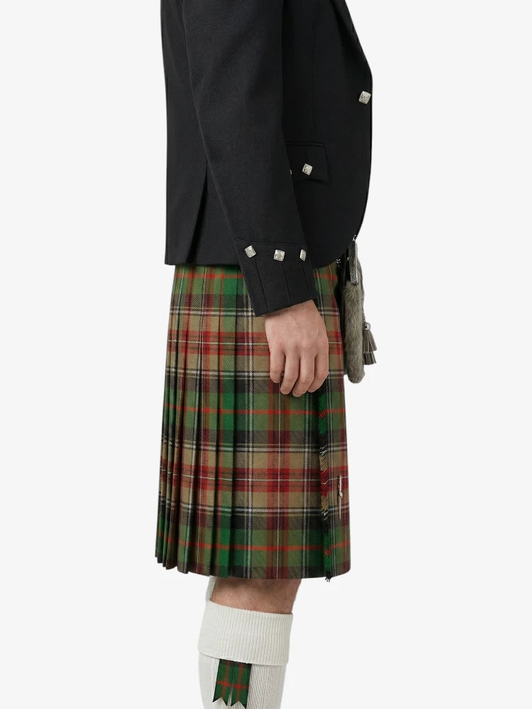 Person wearing a black jacket and green plaid kilt on a white background