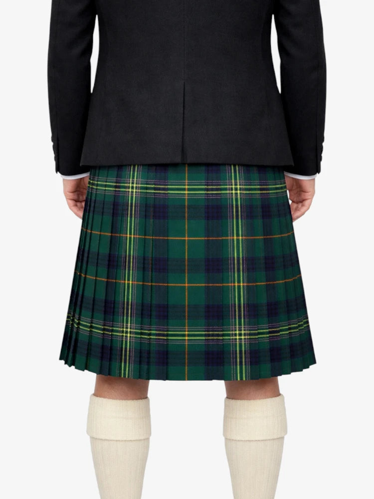 Person wearing a black jacket and green plaid kilt on a white background