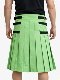 Green pleated skirt with black straps worn by a person on a white background