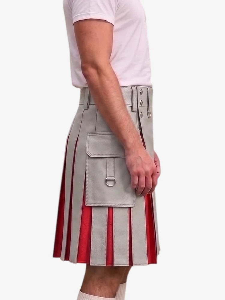 A side view of a model wearing a light gray faux-leather kilt with red vertical pleated stripes and silver buckle details, paired with a white t-shirt and white socks, against a plain white background.