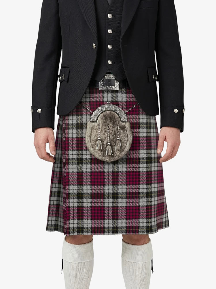 Person wearing a traditional Scottish kilt with a jacket on a white background