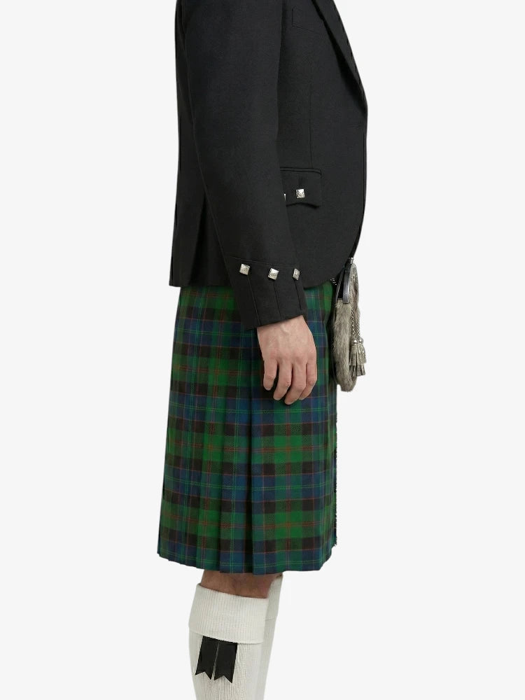 Person wearing a black jacket and green plaid kilt on a white background