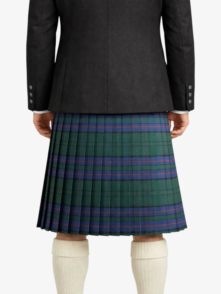 Person wearing a black jacket and green plaid kilt on a white background