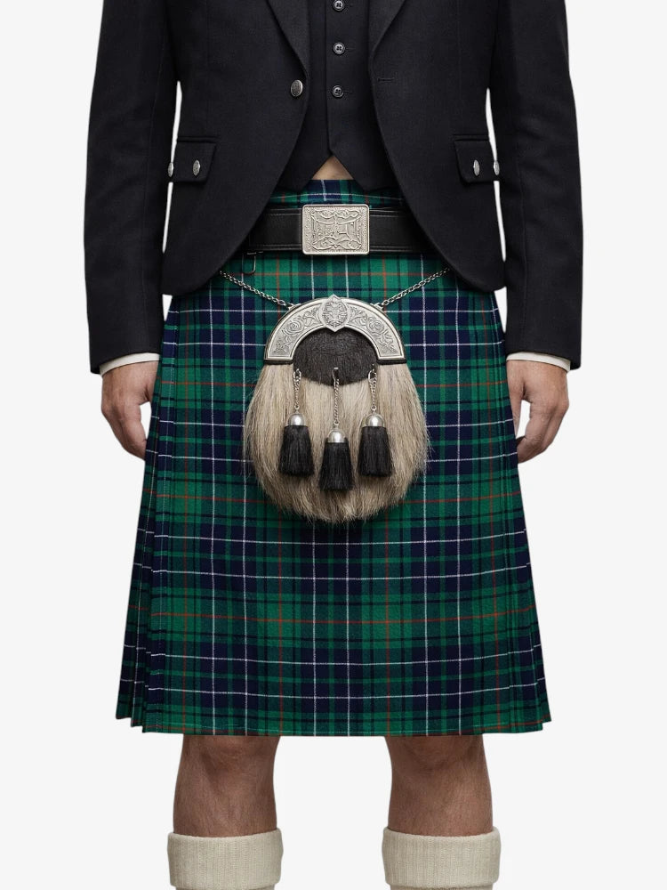 Person wearing a traditional Scottish kilt with a tartan pattern on a white background