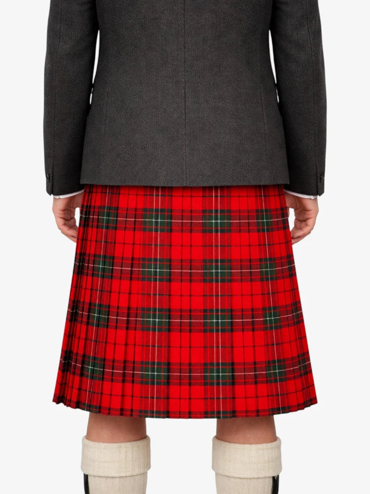 Person wearing a gray jacket and red plaid kilt on a white background