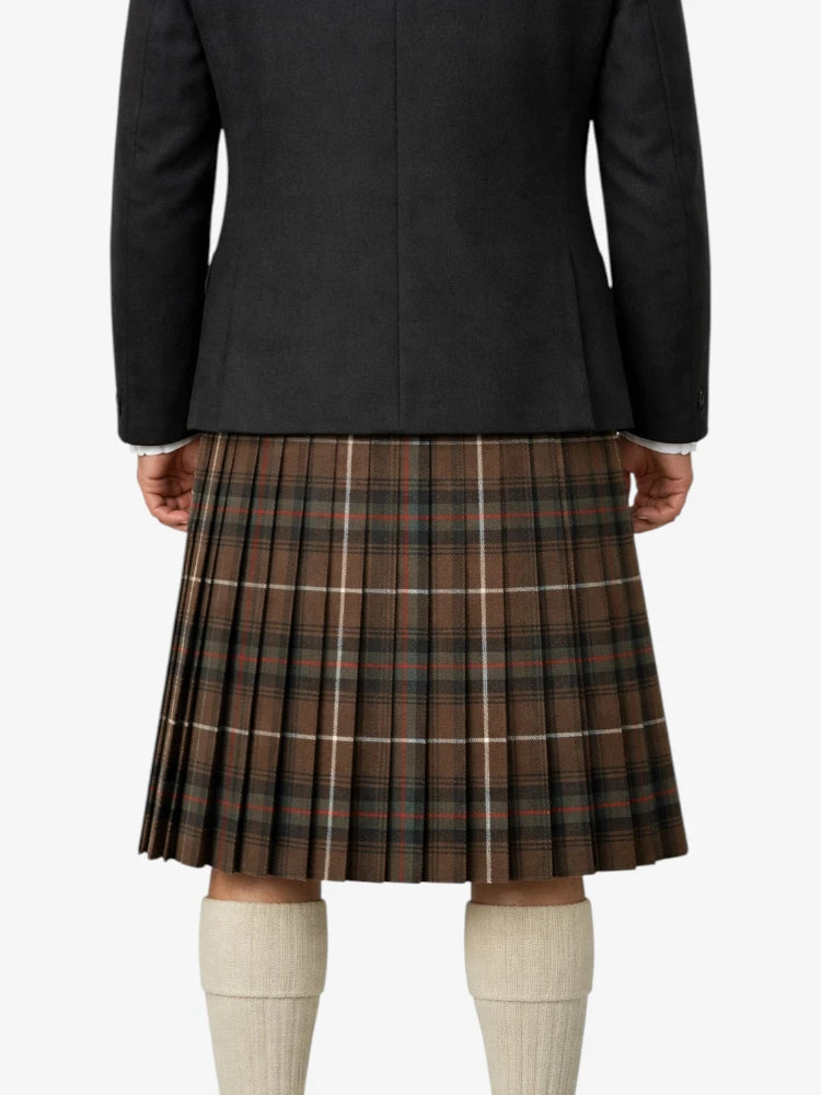 Person wearing a black jacket and plaid kilt on a white background