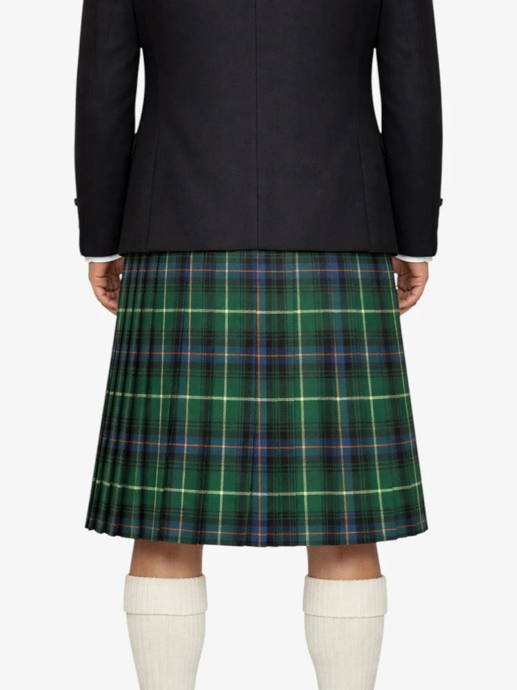 Person wearing a black jacket and green plaid kilt on a white background