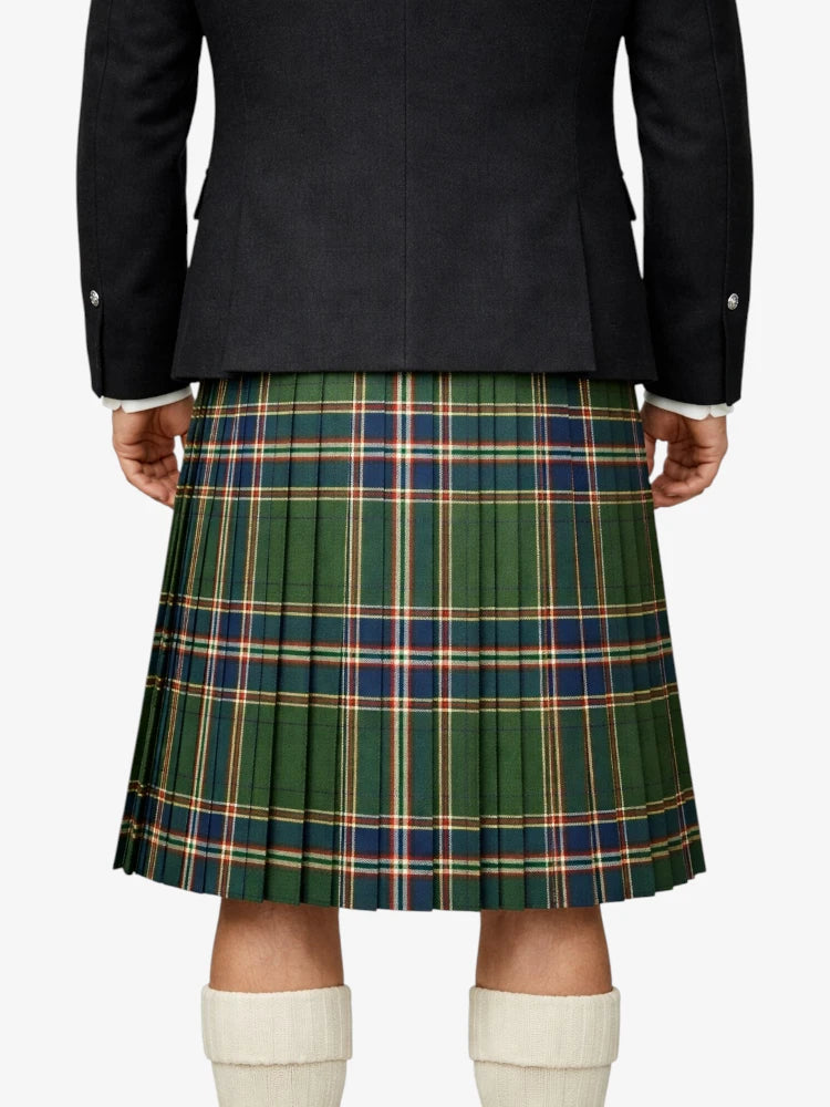 Person wearing a dark jacket and green plaid kilt on a white background