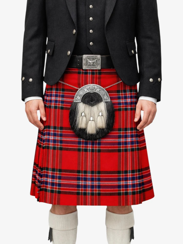 Person wearing a red tartan kilt with a black jacket on a white background