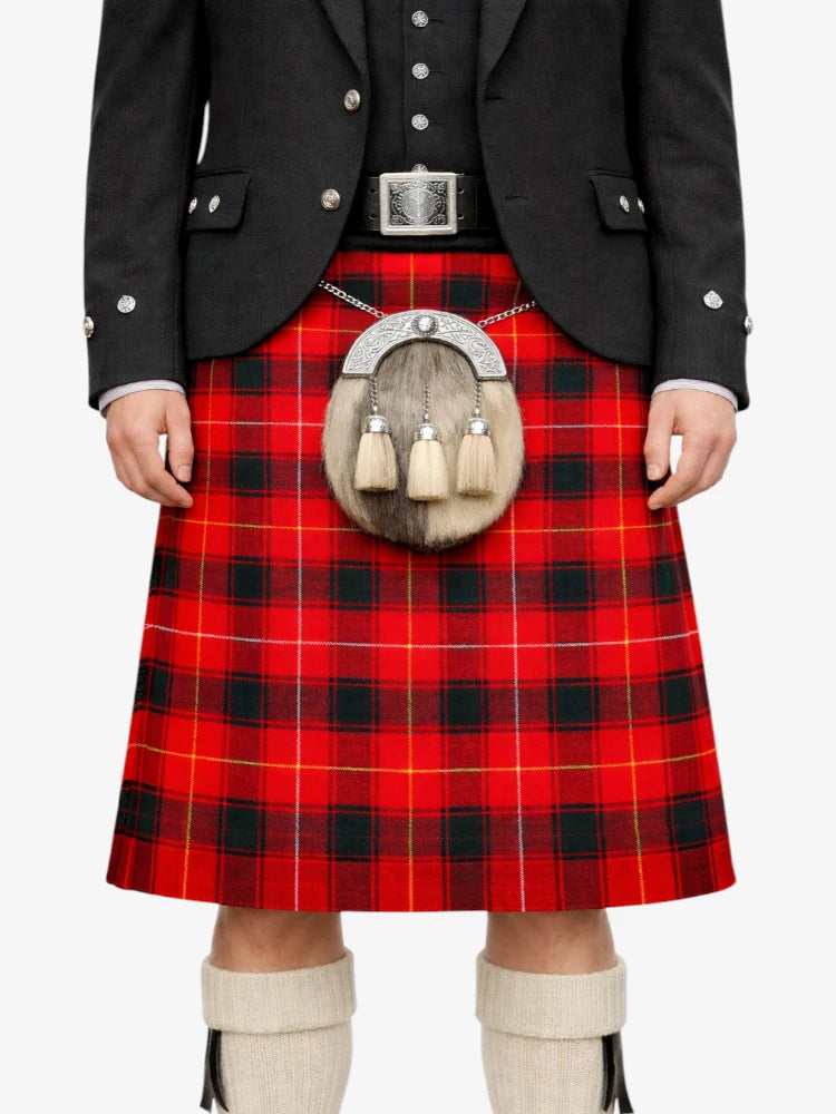 Person wearing a red tartan kilt with a black jacket and white knee-high socks on a white background